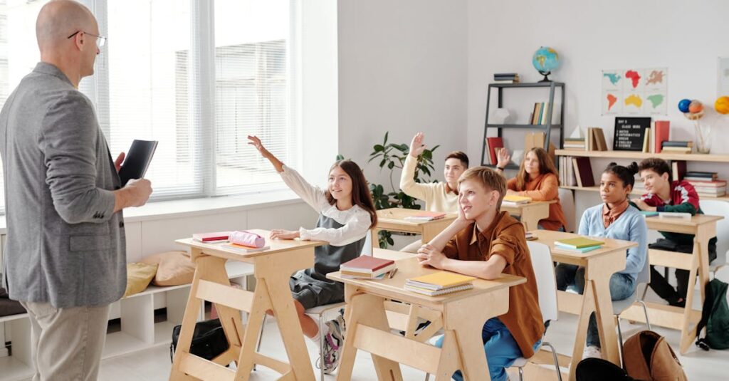 Students engage eagerly in a classroom, raising hands and participating in a lesson with their teacher.